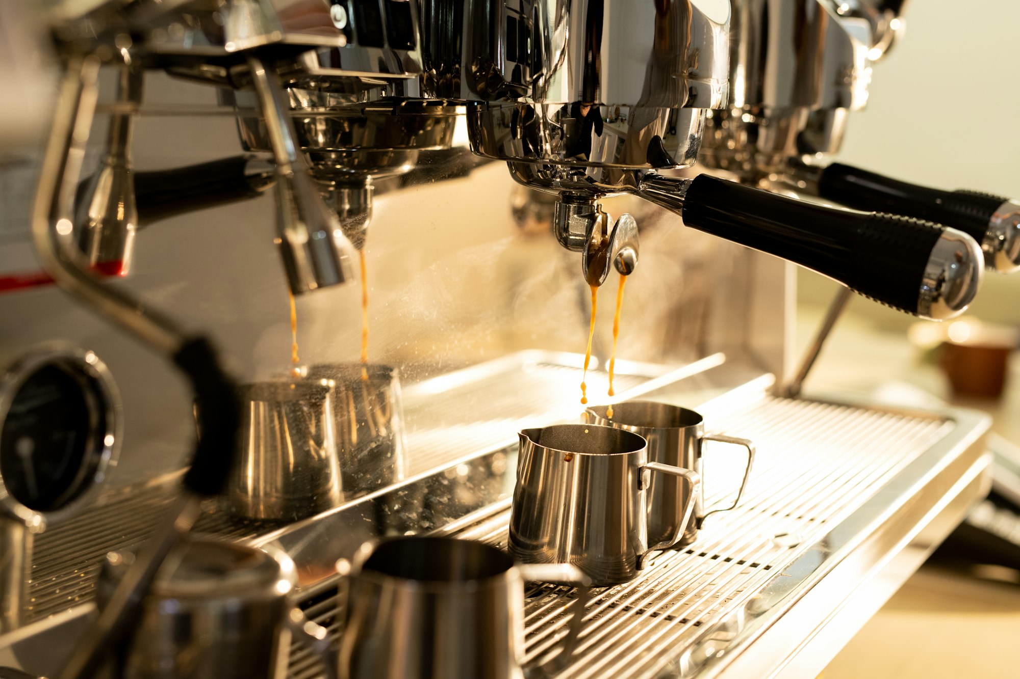 Espresso machine pouring coffee into jug